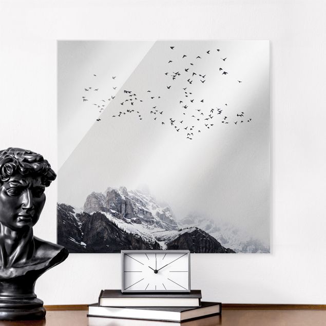 Magnettafel Glas Flock Of Birds In Front Of Mountains Black And White