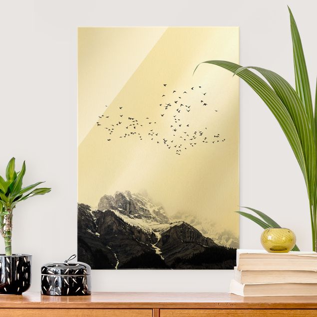 Magnettafel Glas Flock Of Birds In Front Of Mountains Black And White